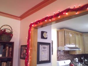 Valentine's garland made with red Christmas lights wrapped around one of my babywearing wraps.