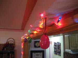 Easter eggs dangle from the lights. I used Christmas ribbon and poked it through the holes in the eggs to make loops to hang them from.