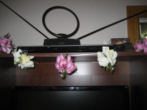 Lilies that I had from somewhere clipped on to a ribbon graces the entertainment center.