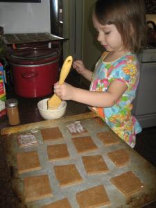 Brushing on some cream before we sprinkle with cinnamon and sugar.